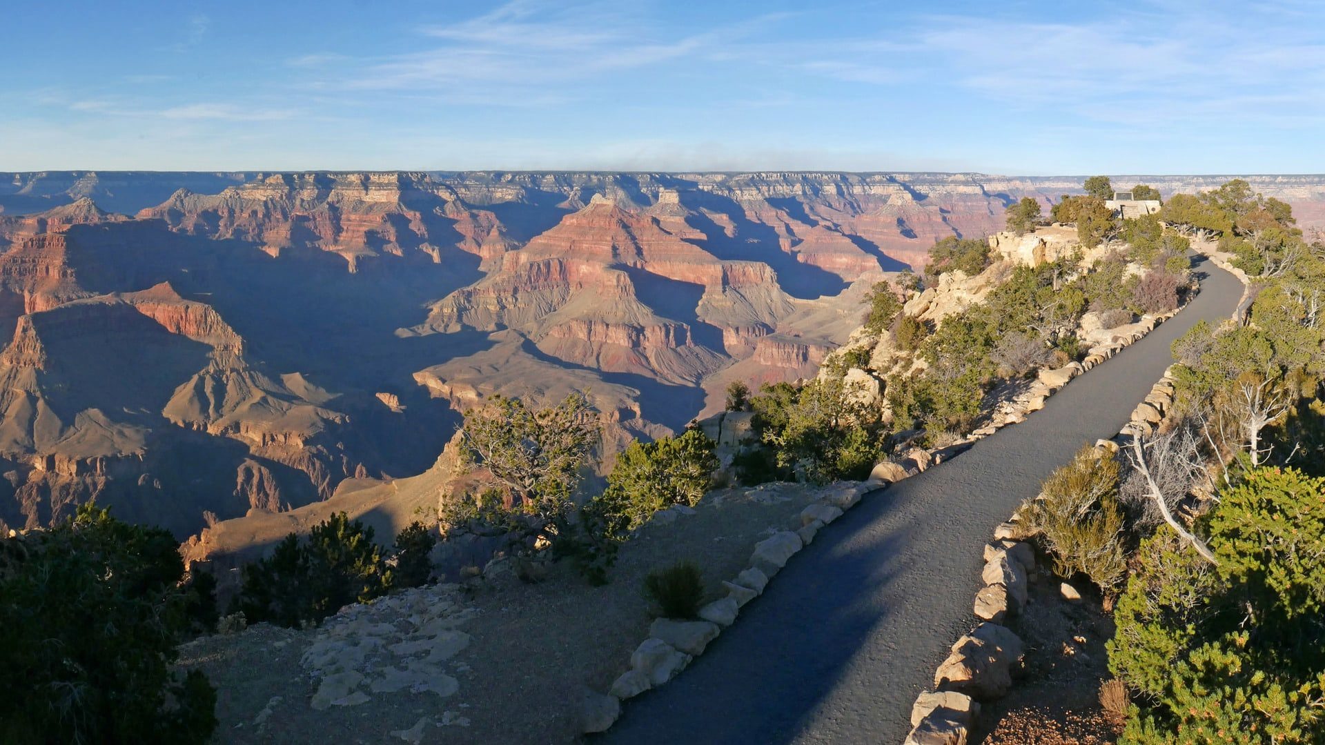 a sweeping view of the grand canyon and a curving road