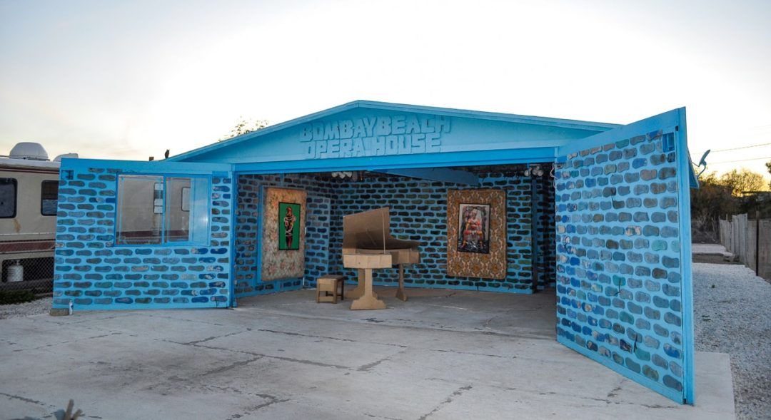The Bombay Beach Opera House, a small, blue structure with wide open doors