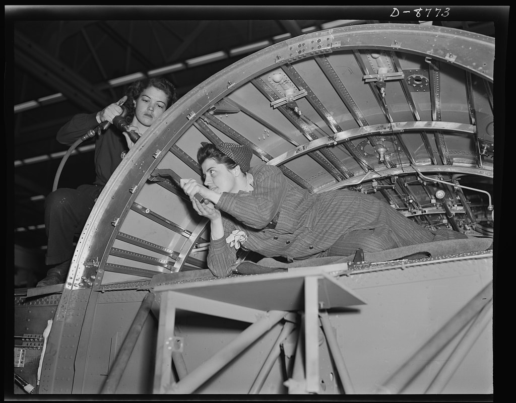 "Rosies" working on a center wing section of a B-24E bomber at the Willow Run plant. 