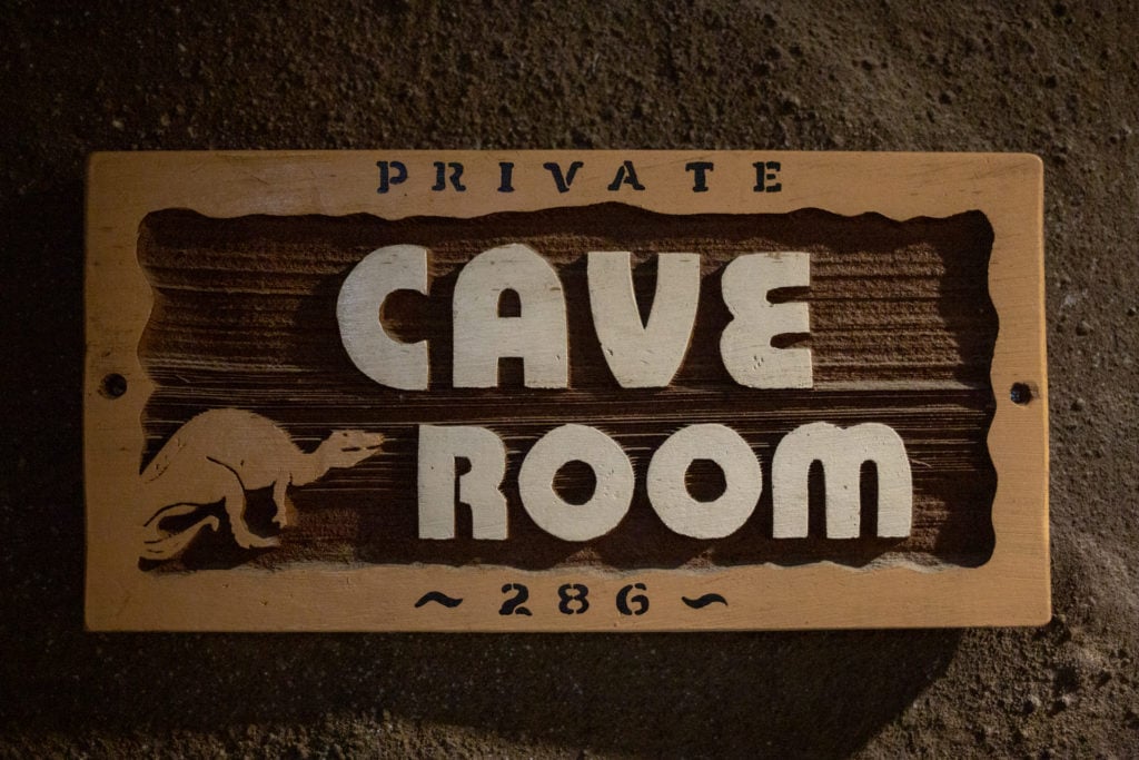 The sign for the Cave Room features a dinosaur