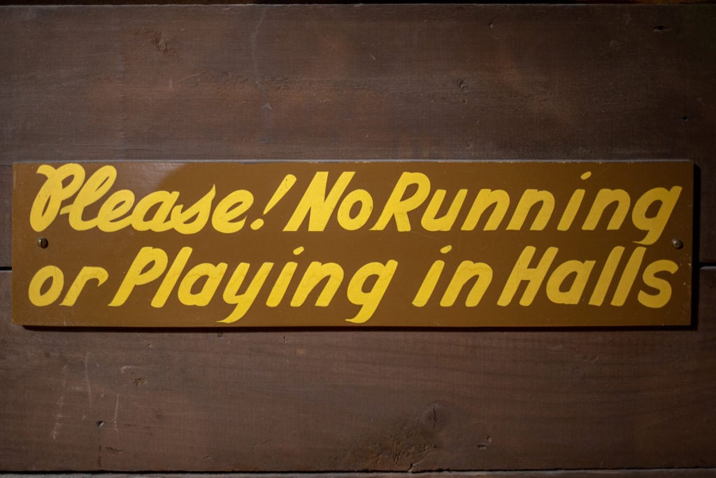 A hand-painted sign that says Please No Running in the Halls