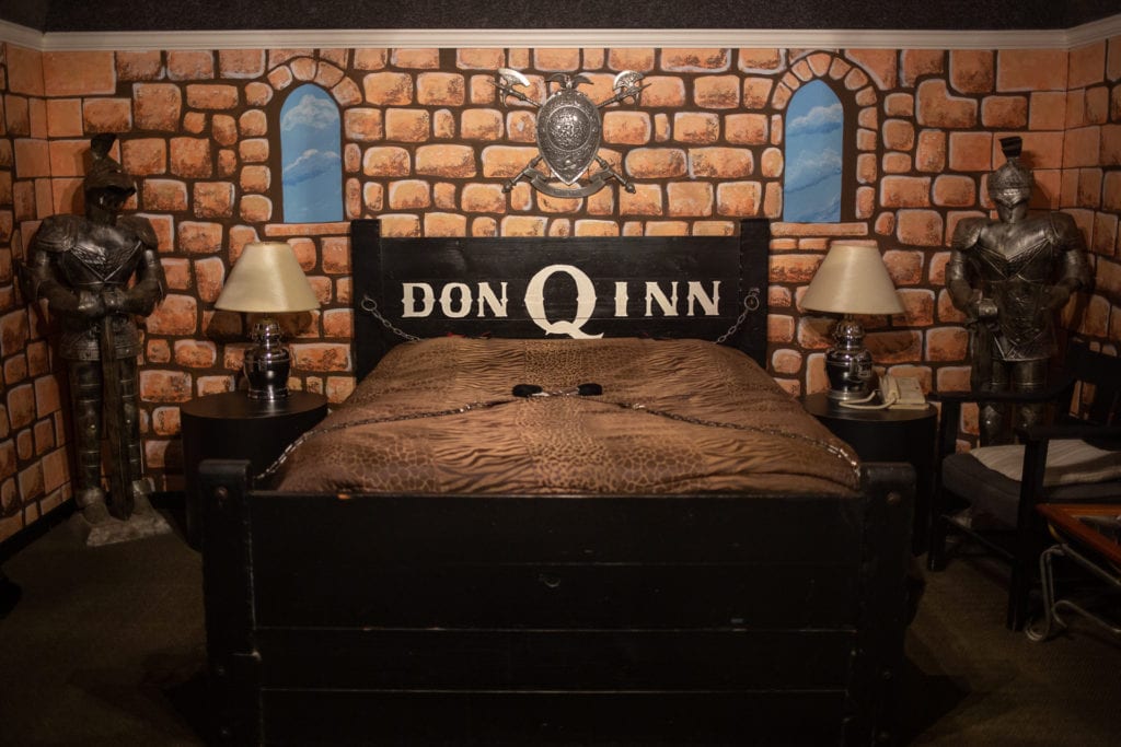 The Mid-Evil room has a leopard-print bedspread and bed shackles chained to the head and foot boards