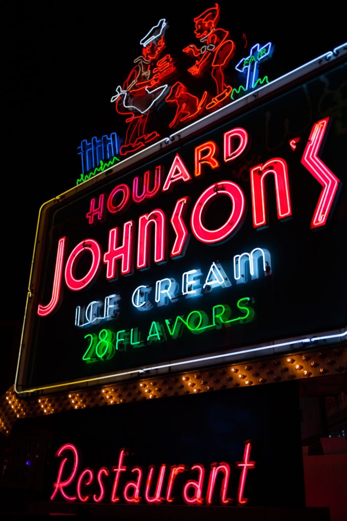 A large, neon sign from the Howard Johnson's restaurant advertising 28 flavors of ice cream