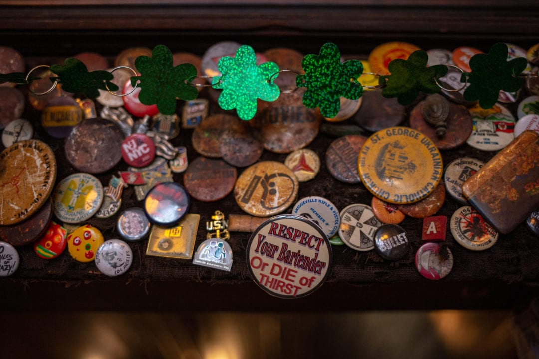 Various buttons, patches and pin left at McSorley's by patrons