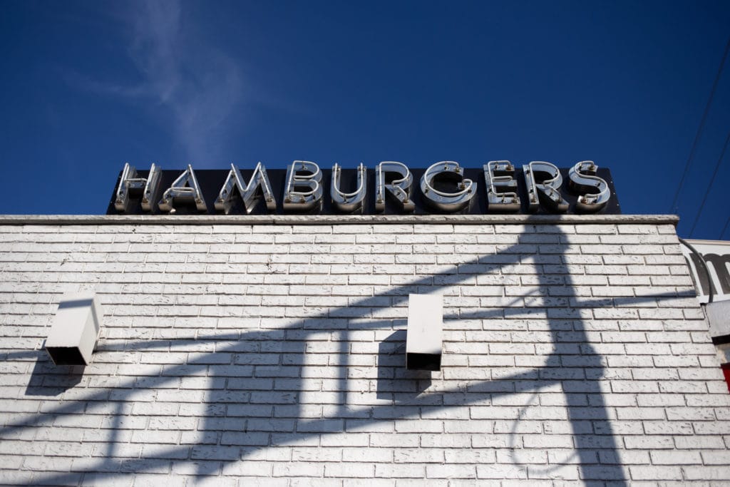 A neon sign spelling out hamburgers