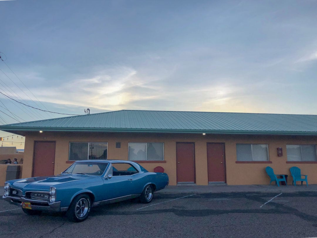 A vintage GTO sits in front of one of the rooms of the Sunset Motel.