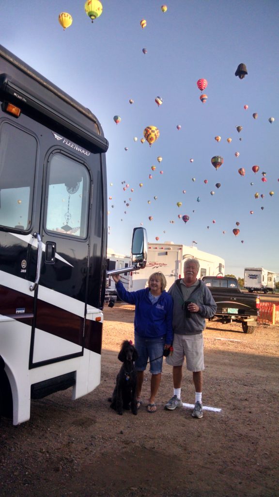 Judy, her husband Donny, and their dog BB at the Hot Air Balloonfest in New Mexico
