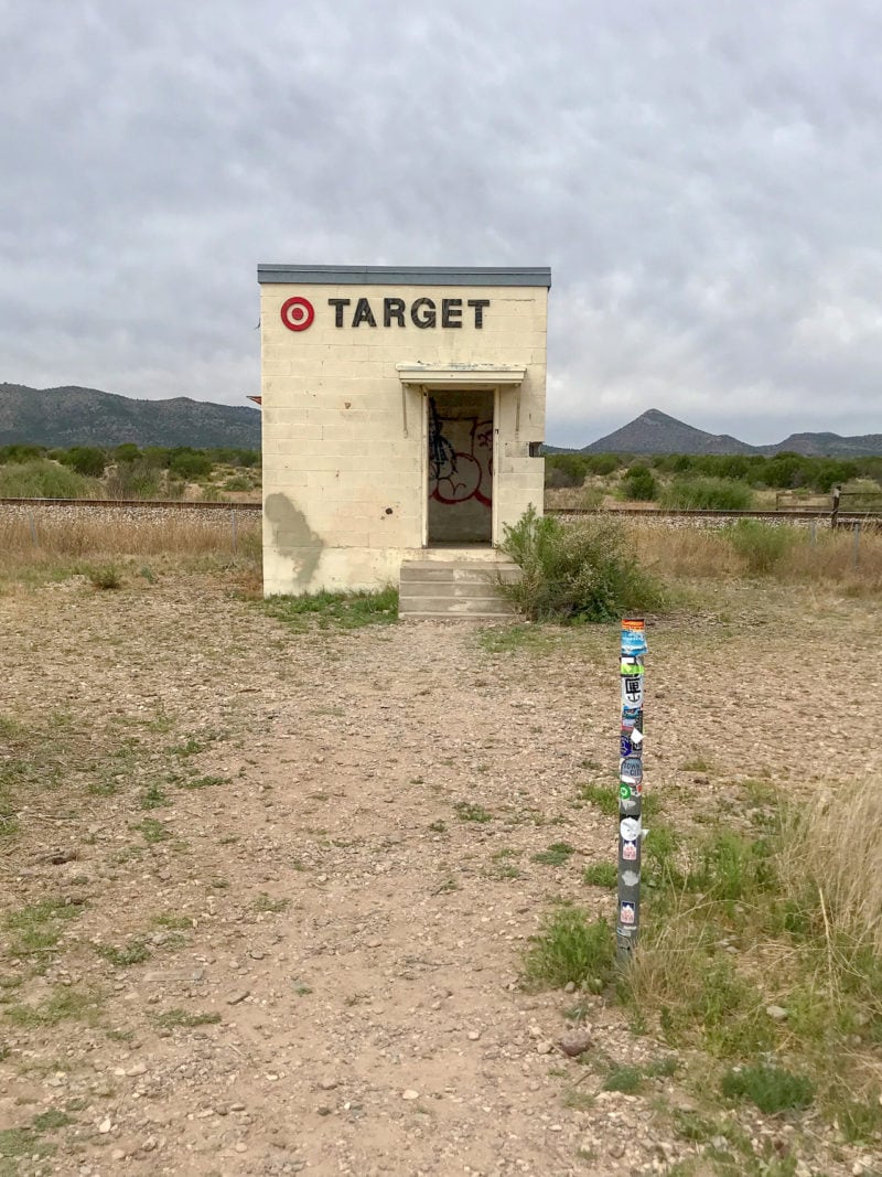 The Target Marathon, a tiny, stand-alone building in the middle of the desert beside train tracks.