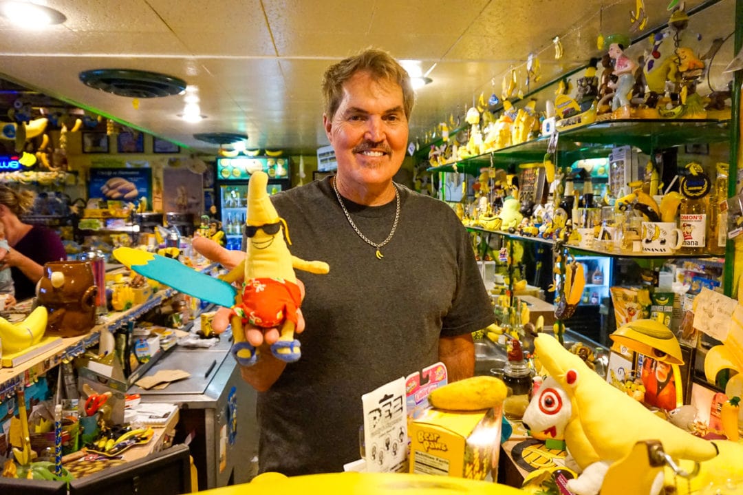 Fred Garbutt with one of his favorite items in the museum: a surfing banana