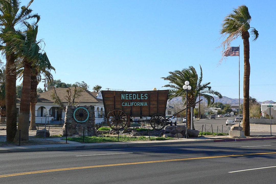 A giant wagon that reads "Needles California" on the side.