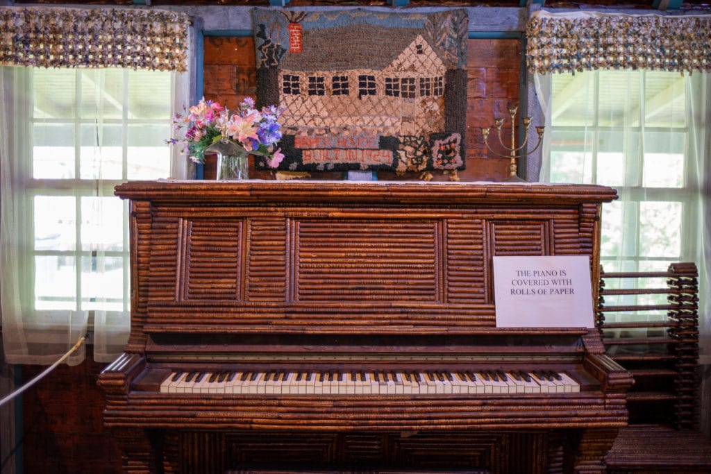 a piano covered in paper rolls