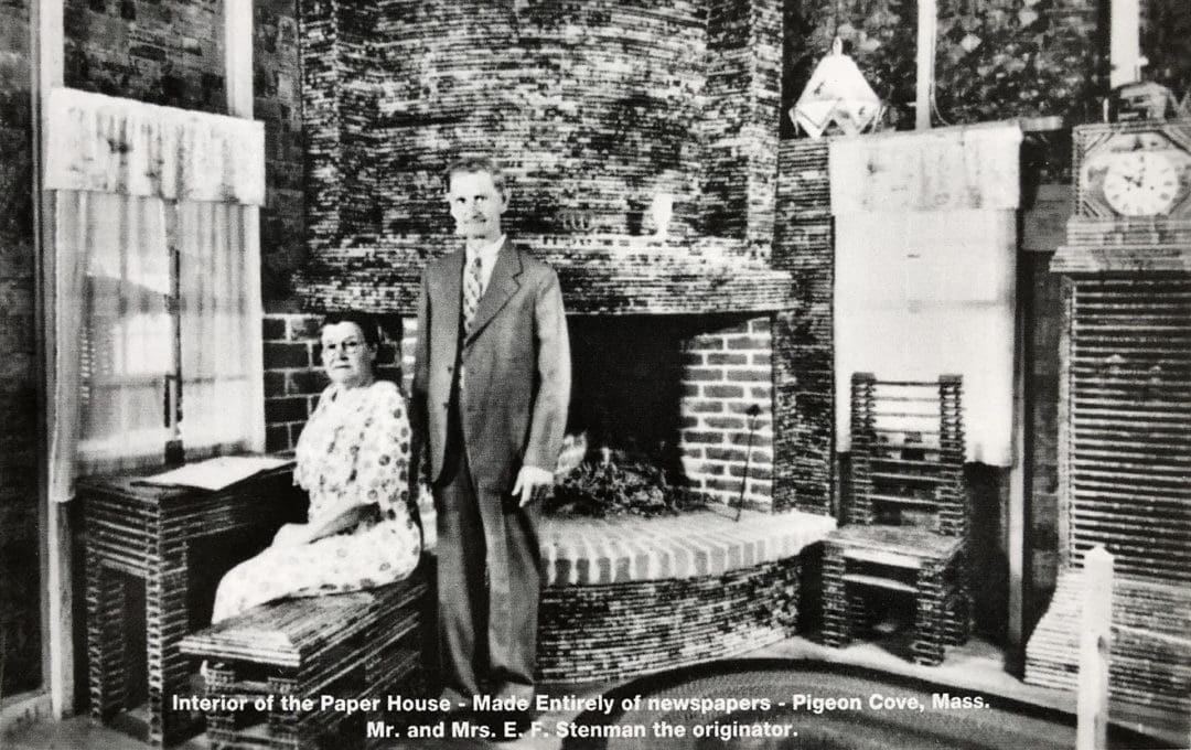 The Stenmans sitting by their fireplace in the Paper House