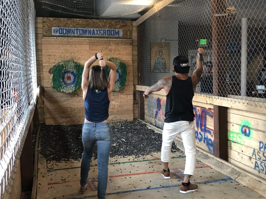 Stephen Ezeonu, right, showing the proper axe throwing form