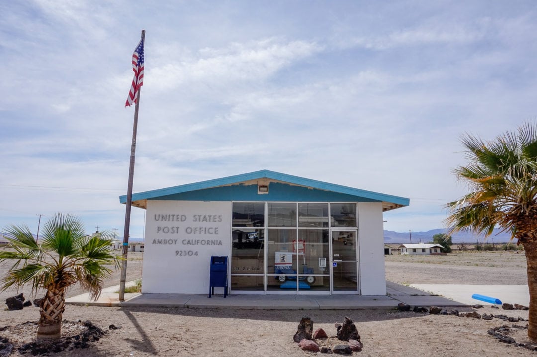 A one-room post office stands alone in the desert