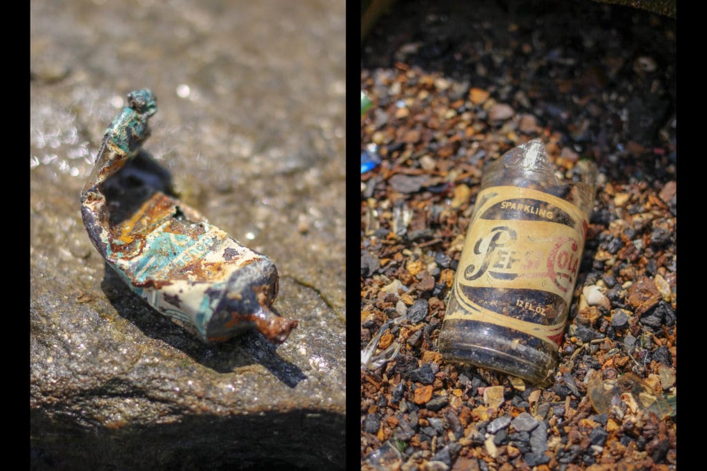 a rusty metal tube and a pepsi bottle