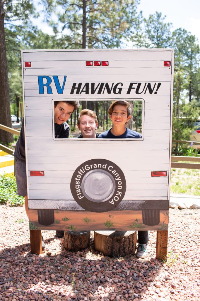 Boys posing in the RV cutout at the campground