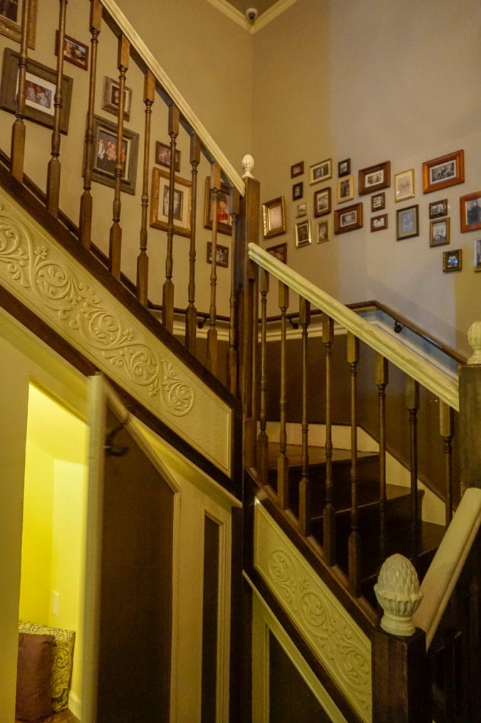 A turning staircase with framed family photos. 