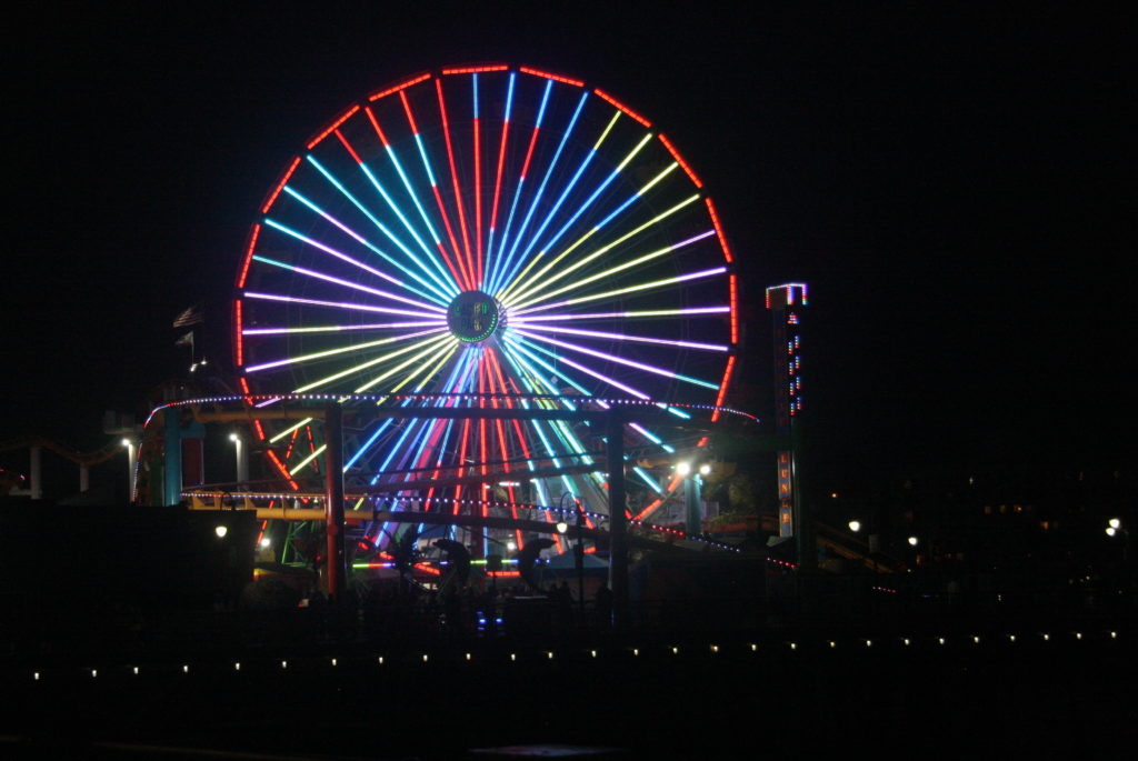 The ferris wheel at the Santa Monica Pier glows bright at night