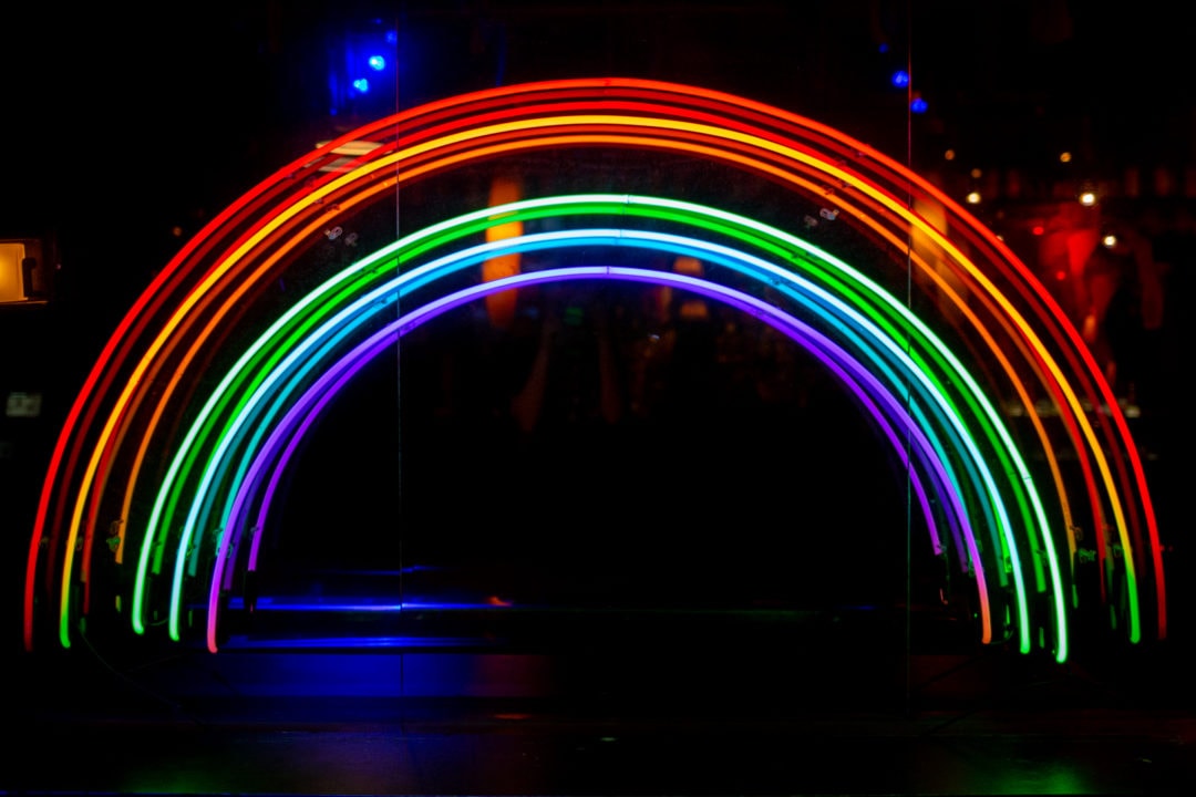 A neon rainbow inside of the Stonewall Inn.