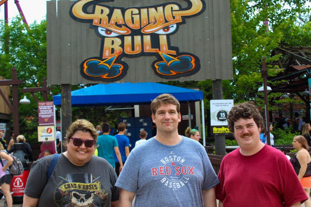 Joanna, Rob, and AJ in front of the Raging Bull ride at Six Flags Great America amusement park