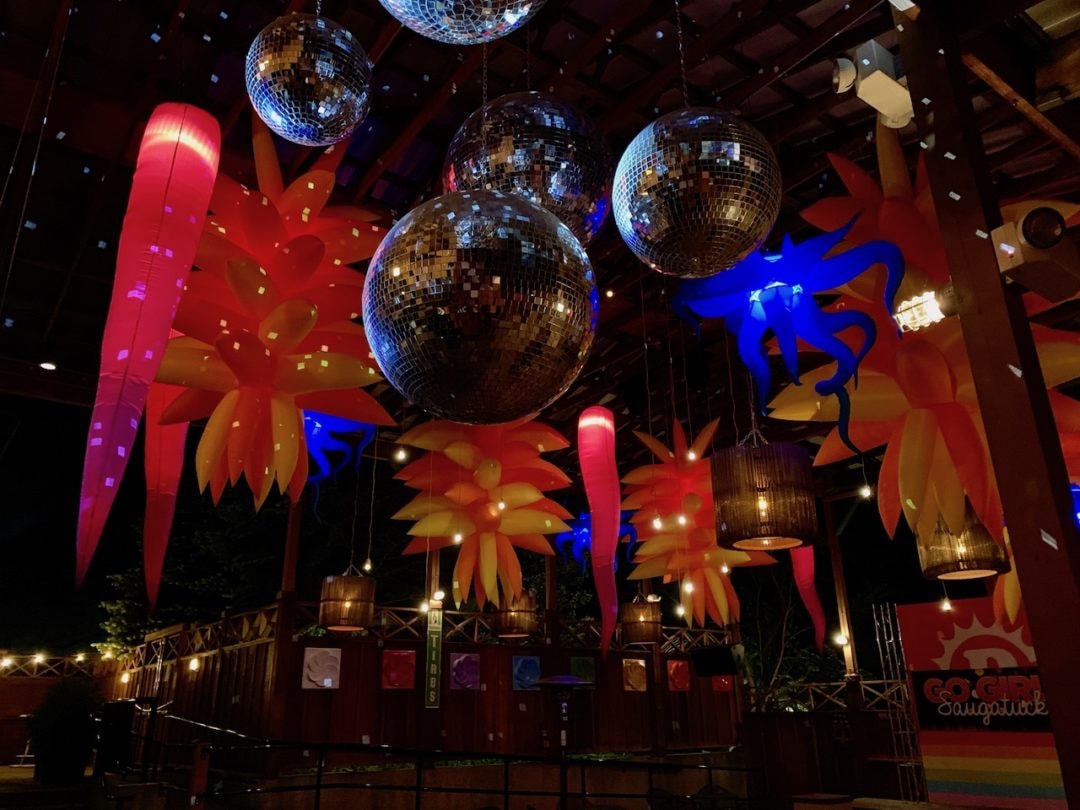 Disco balls and inflatable lights line the ceilings of the bar