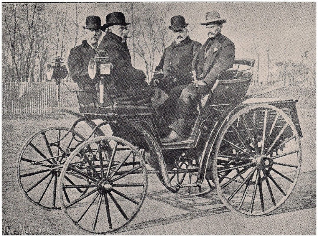 Some of the race officials and drivers sitting in an 1895 Mueller-Benz automobile.
