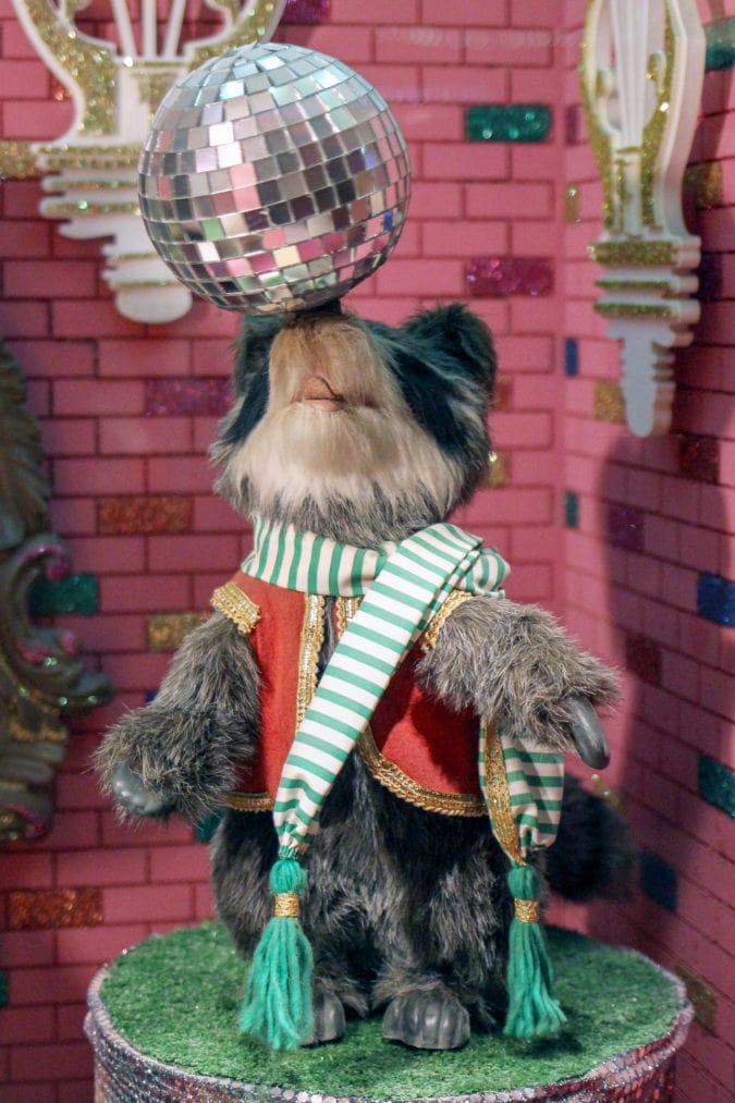 A disco raccoon in a pink room