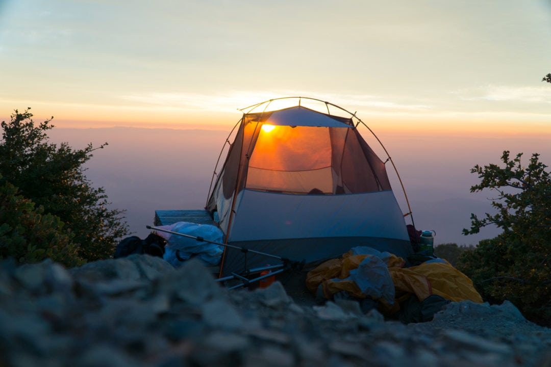 A view of a tent during sunrise. 