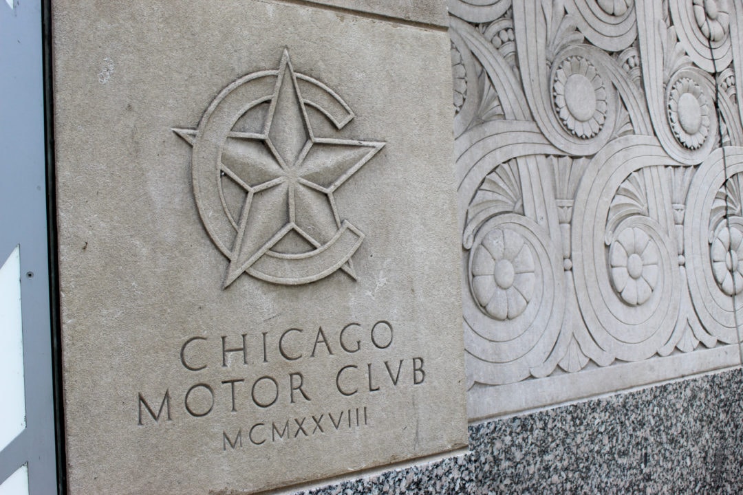 The outside of the building includes detailed Art Deco-style carvings, along with the club's symbol. 