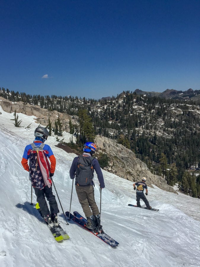 people in patriotic garb ski and snowboard downhill