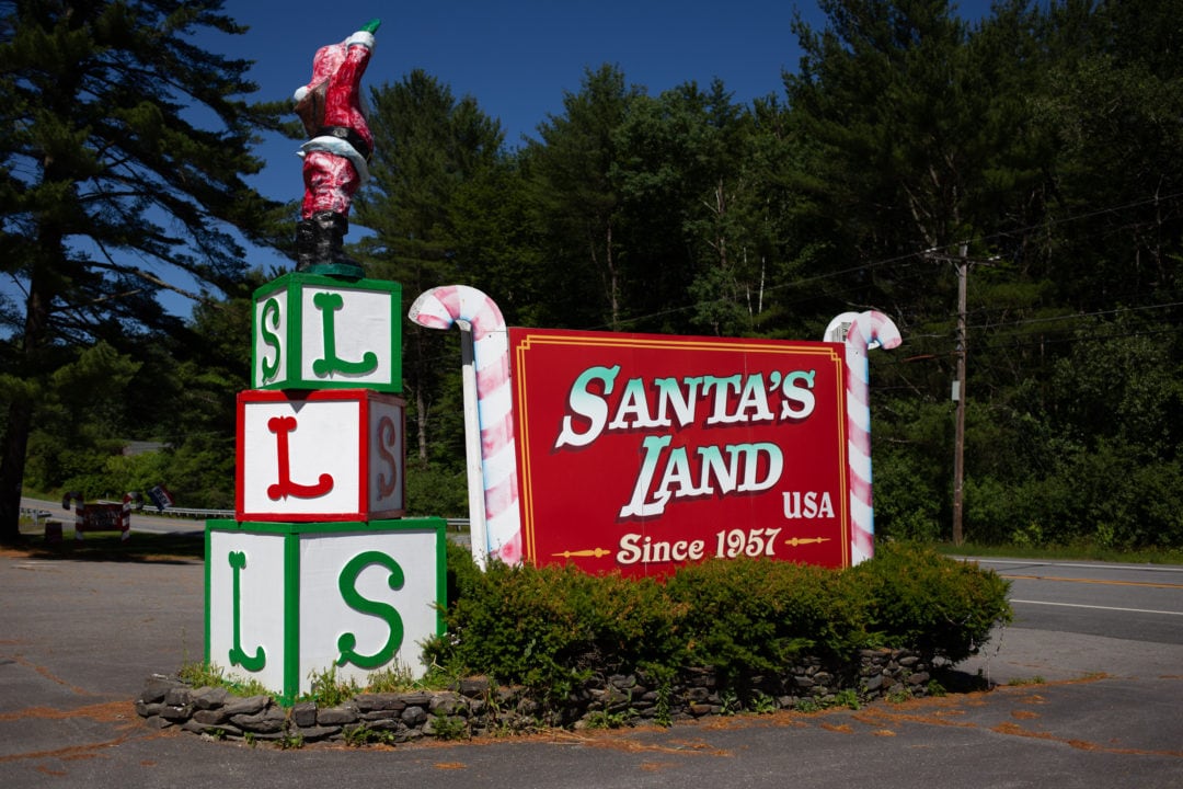 santa's land sign flanked by candy canes and greenery