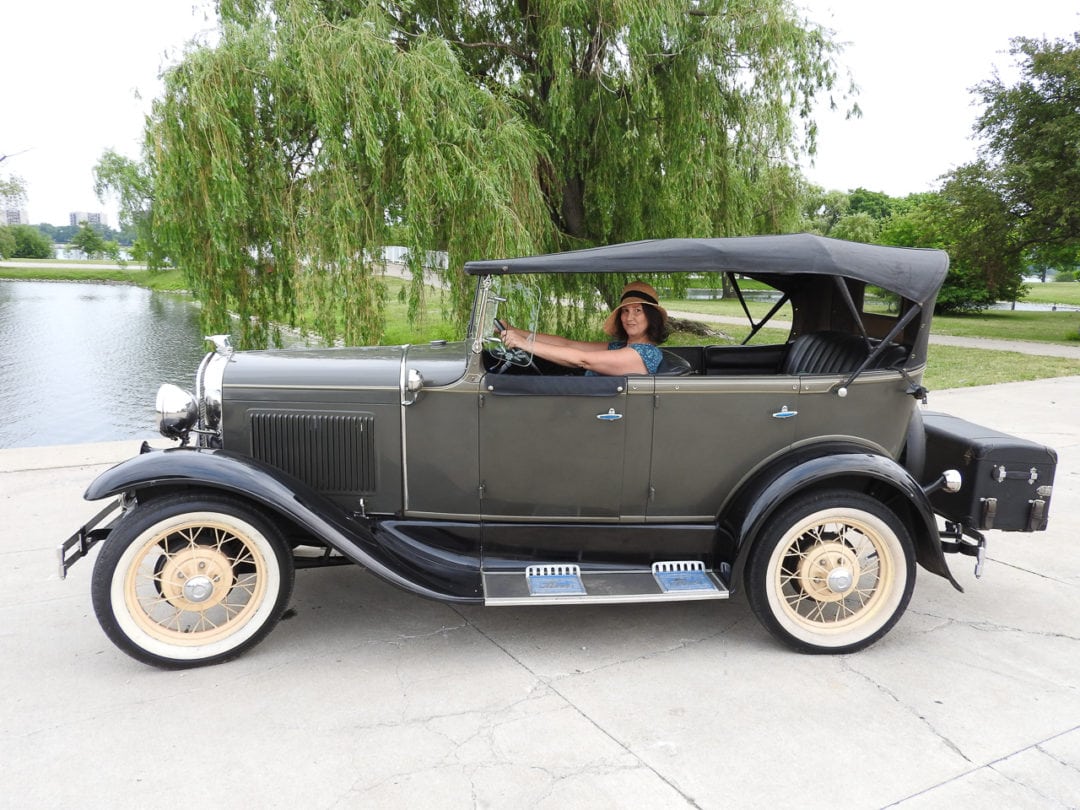 Lisa Stolarski, owner and founder of Antique Touring, in her 1930 Ford Model A Phaeton, on Belle Isle. 