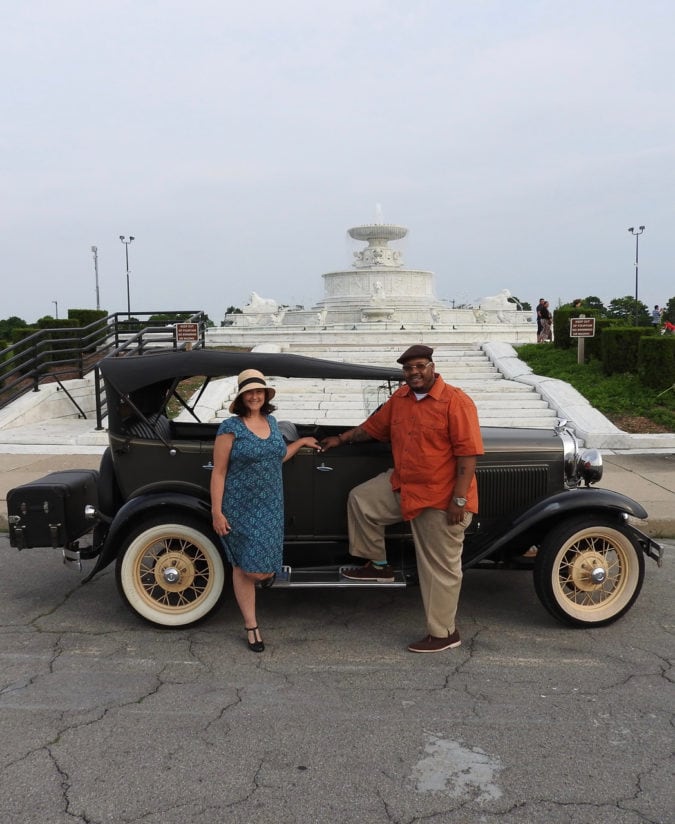 Lisa and Rick, the drivers for Antique Touring, with one of their Model A vehicles in front of the James Scott Memorial Fountain on Belle Isle. 