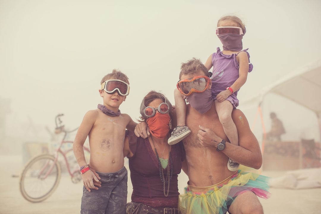 Parents and two children wearing masks and goggles 