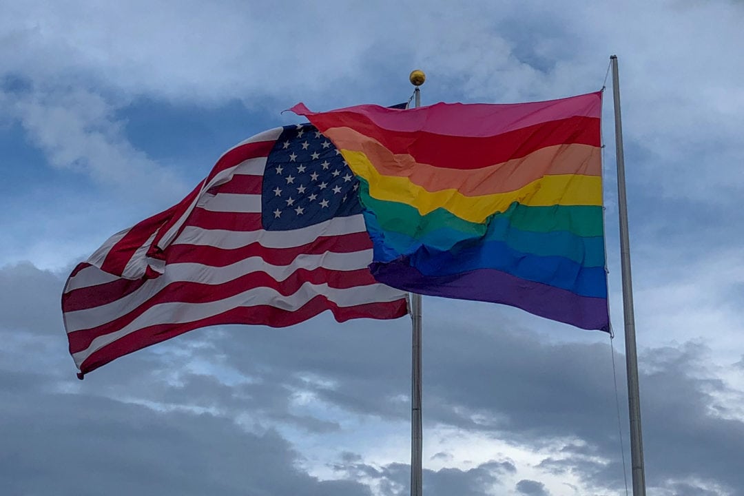 Two flags welcome visitors to Fire Island: an American flag and a rainbow flag