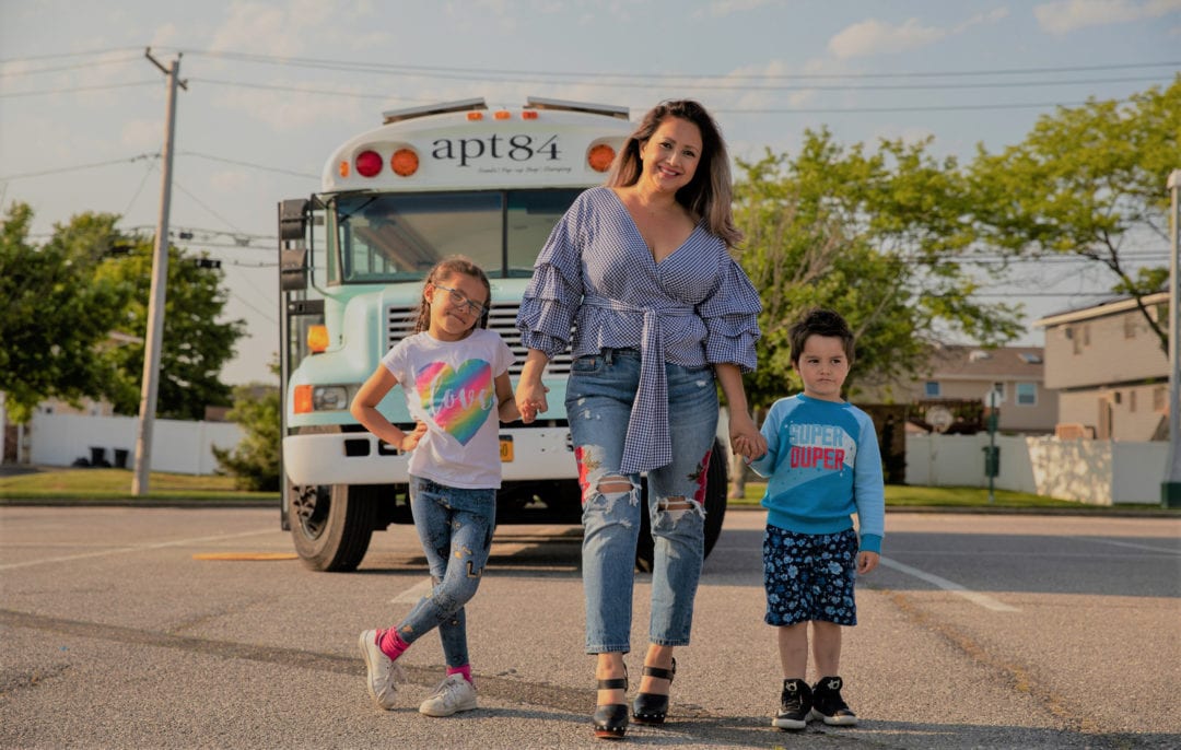 Catherine Ovejas and her children in front of a school bus