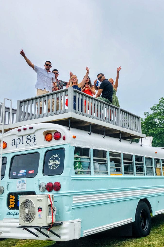 people partying on top of a school bus
