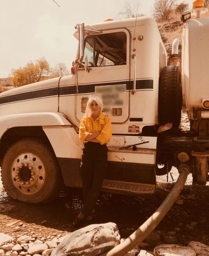 Brittany Burnett in front of a water truck