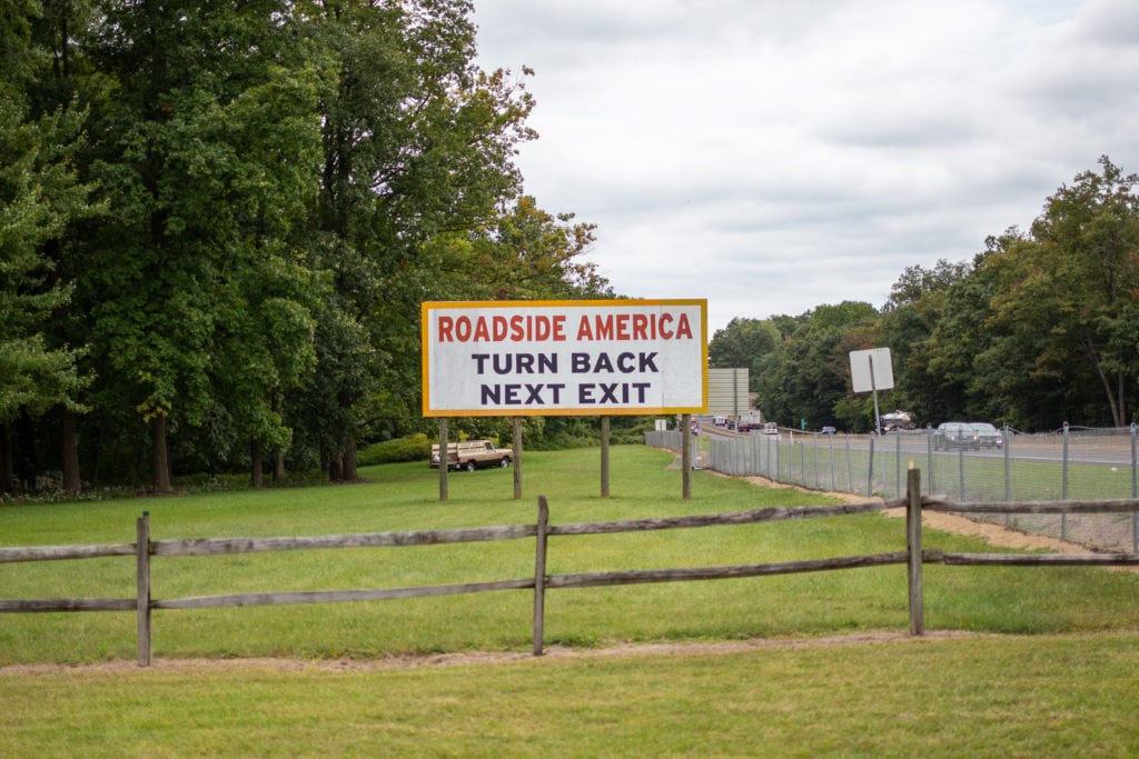 A billboard urges travelers to turn back