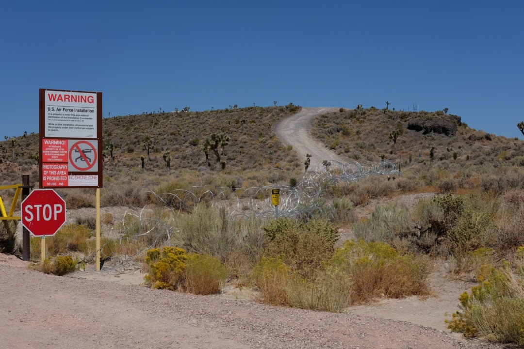 Area 51’s perimeter is patrolled by armed guards and surrounded by patches of barbed wire and surveillance cameras.