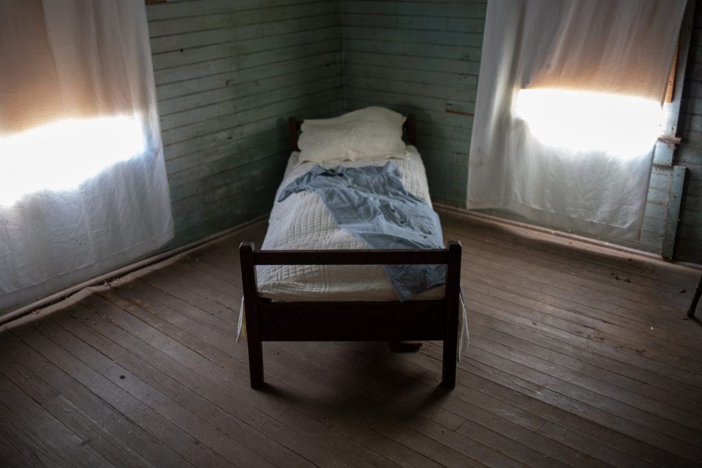A bed inside of the Everdeen house.