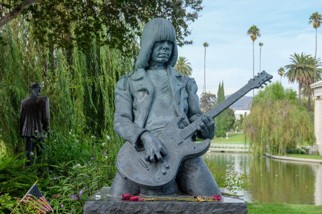 Johnny Ramone’s grave is marked by a life-size statue and inscribed with quotes about his life from famous friends.