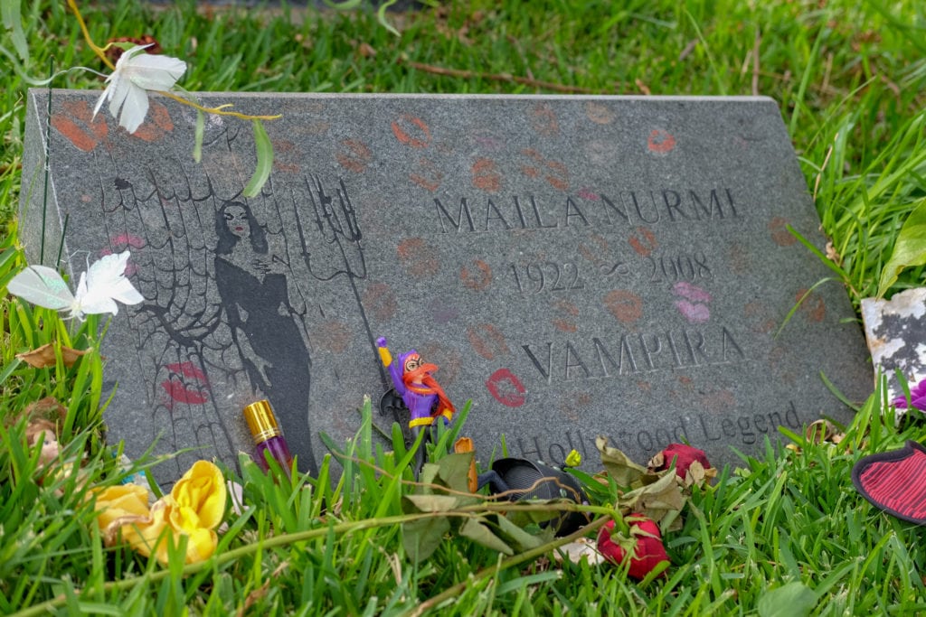 the headstone for Maila Nurmi (more commonly known as her horror character “Vampira”) is adorned with bright red and pink lipstick kisses.