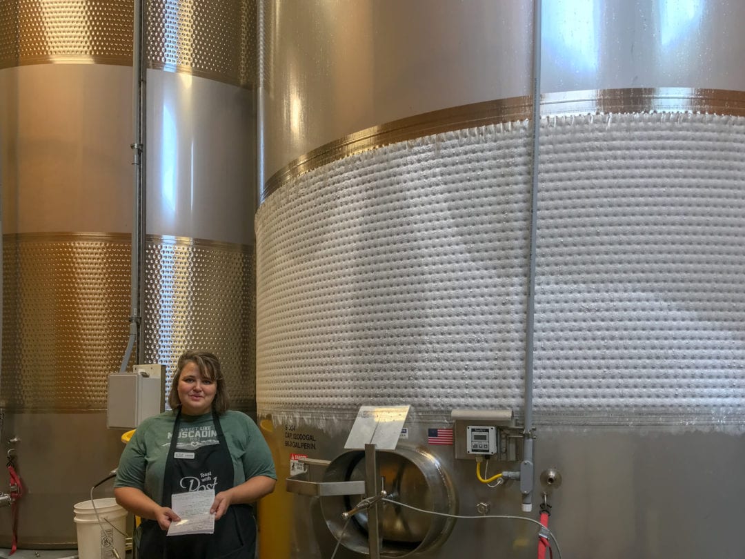 Kristin Mengis in front of a fermentation tank at Post Familie Winery.