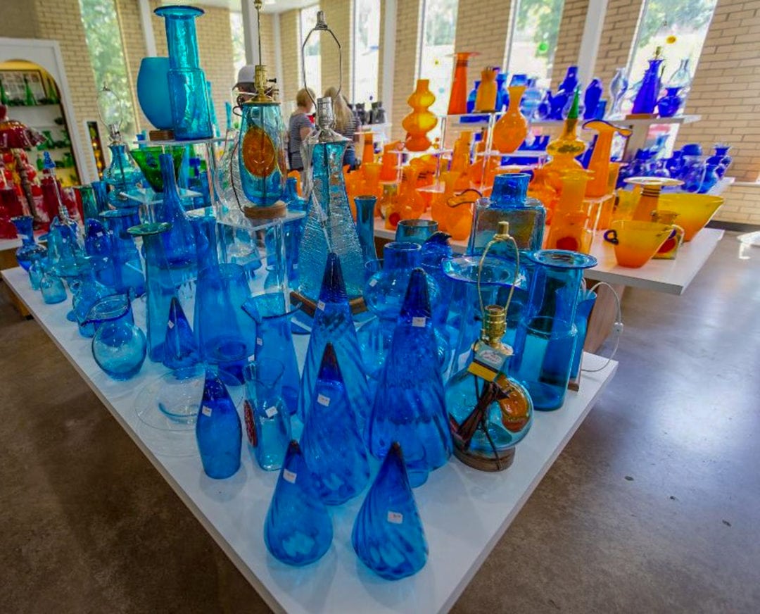 An array of glass on display in the Blenko gift shop offers a sample of the colorful hues available. The vivid colors are created by adding metals to the molten glass.