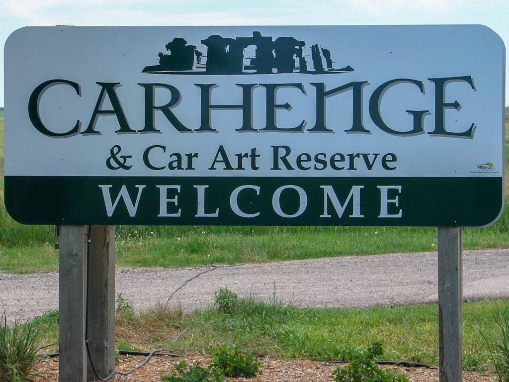 A sign welcomes visitors to Carhenge and Car Art Reserve.