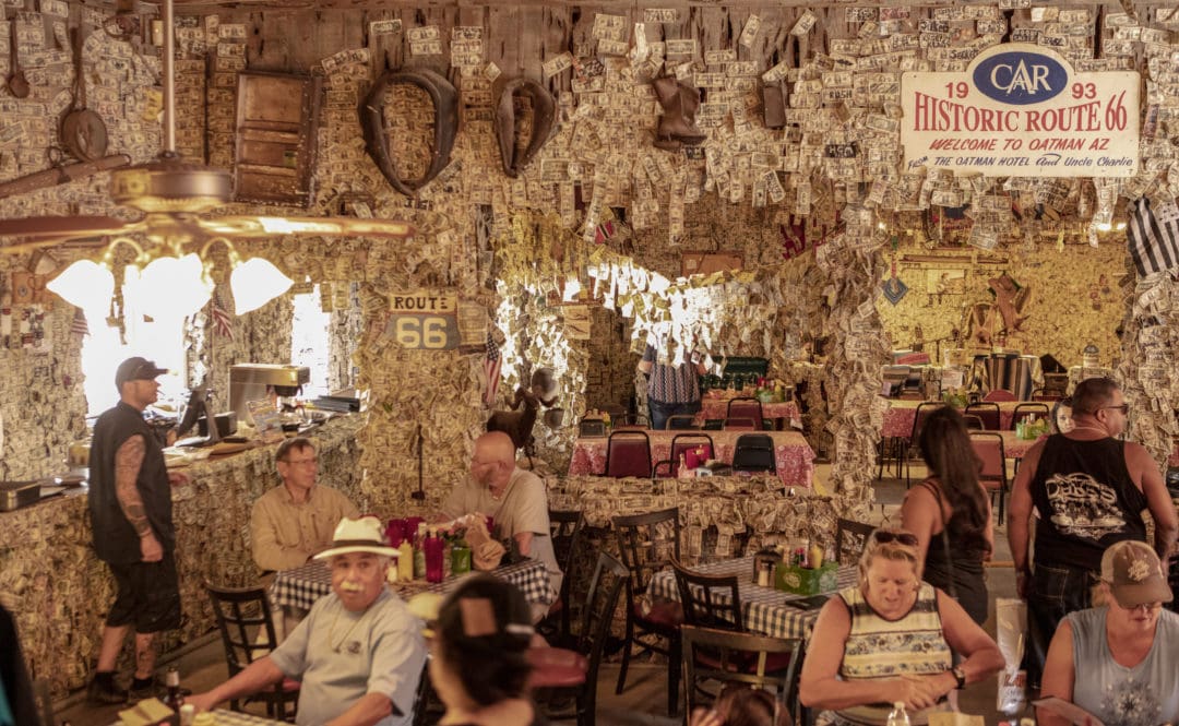 The bar and restaurant of the Oatman Hotel have their walls and ceilings covered in dollar bills signed by tourists
