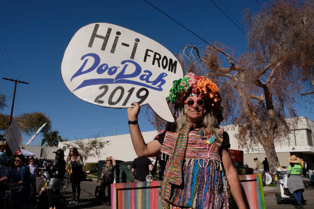 Dennis “The Colorful Guy” Miller marches wearing a rainbow ensemble of woven area rugs. He is one of the original parade performers and waves hello to this year’s approximately 7,000 spectators and 1,000 participants.