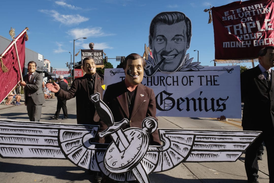 The Church of the SubGenius march for the first time in this year’s Doo Dah. They are a satirical religious cult that began in 1953. These magistrates and believers are wearing masks of the group’s founder, J.R. “Bob” Dobbs. Bob was a salesman who claimed to be given sacred messages from a god-like entity that spoke to him through a television set. Members are guaranteed eternal salvation or triple their money back.