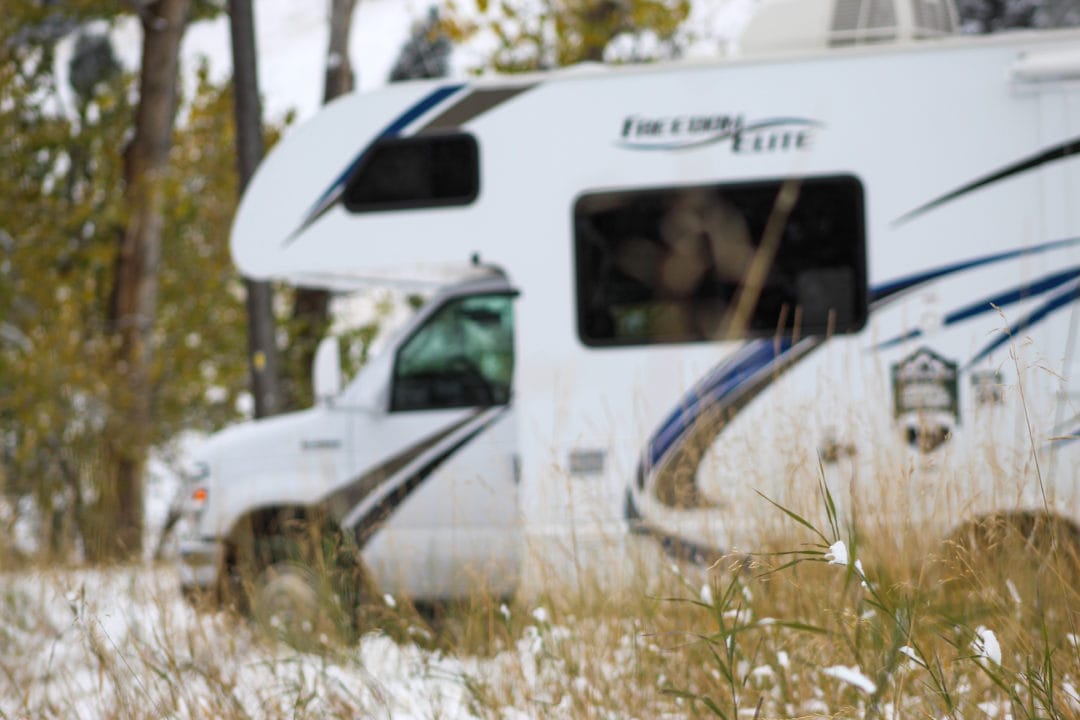 Class C motorhome in snow and snowy grass